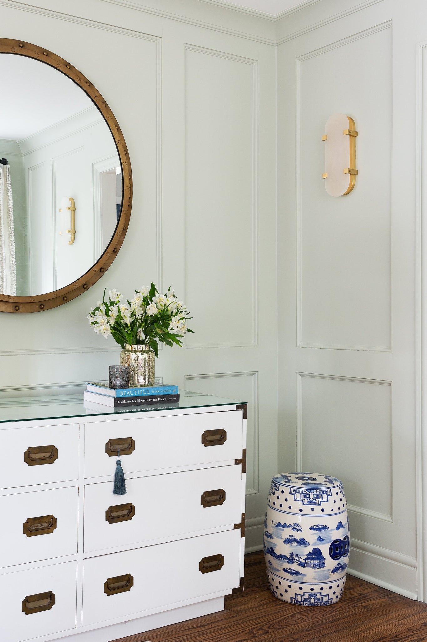 Skylar Wall Sconce 5.75" x 13.75" in aged brass styled in a curated living room for warm, layered light at Laurie Yapp Home.