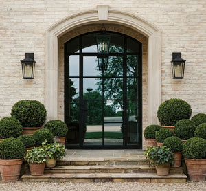 Soren Exterior Wall Sconce 7.5" x 14" styled in a curated living room for warm, layered light at Laurie Yapp Home.