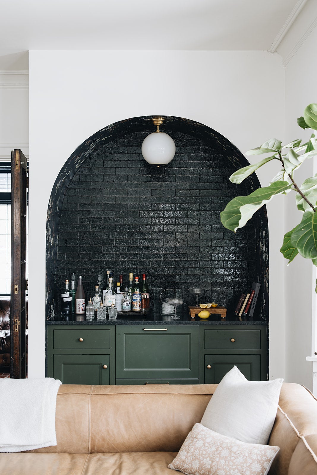 Sphere No.1 Semi Flush in aged brass styled in a hallway for warm, layered light at Laurie Yapp Home.