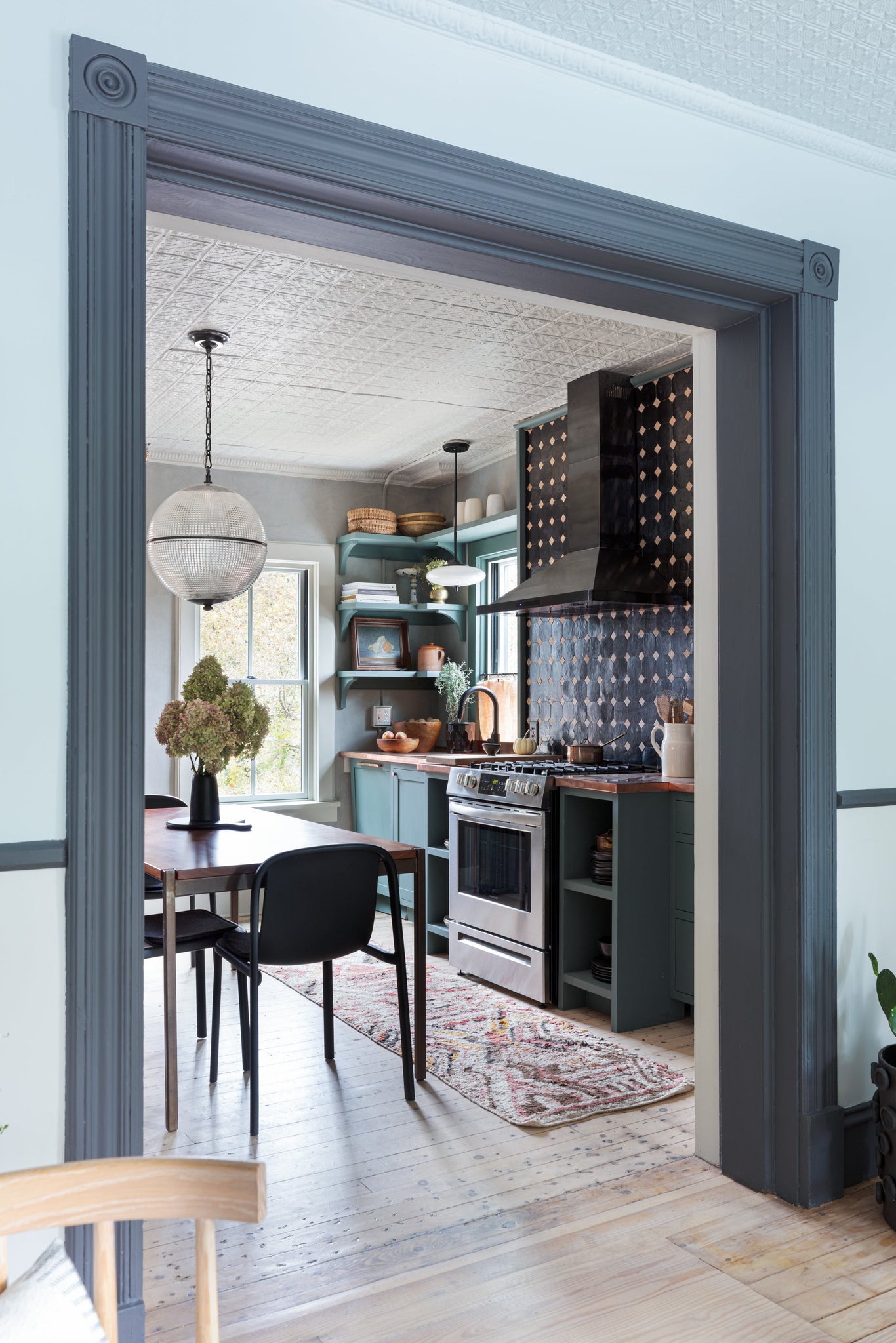 Sphere No. 3 Pendant 18.25" in dark bronze styled in a welcoming entryway for warm, layered light at Laurie Yapp Home.