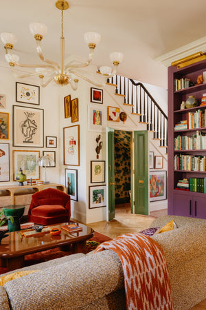 Merrick Picture Light 24.5" in aged brass styled in a reading room for warm, layered light at Laurie Yapp Home.