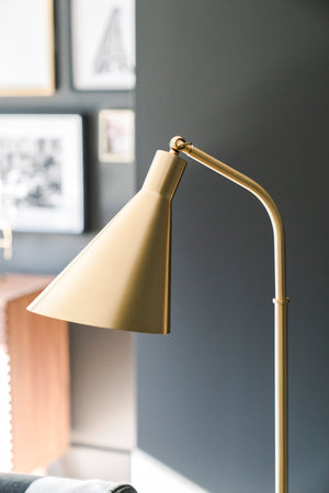 Stanton Floor Lamp in aged brass shown from the front to reveal the stem, base, and shade proportions.