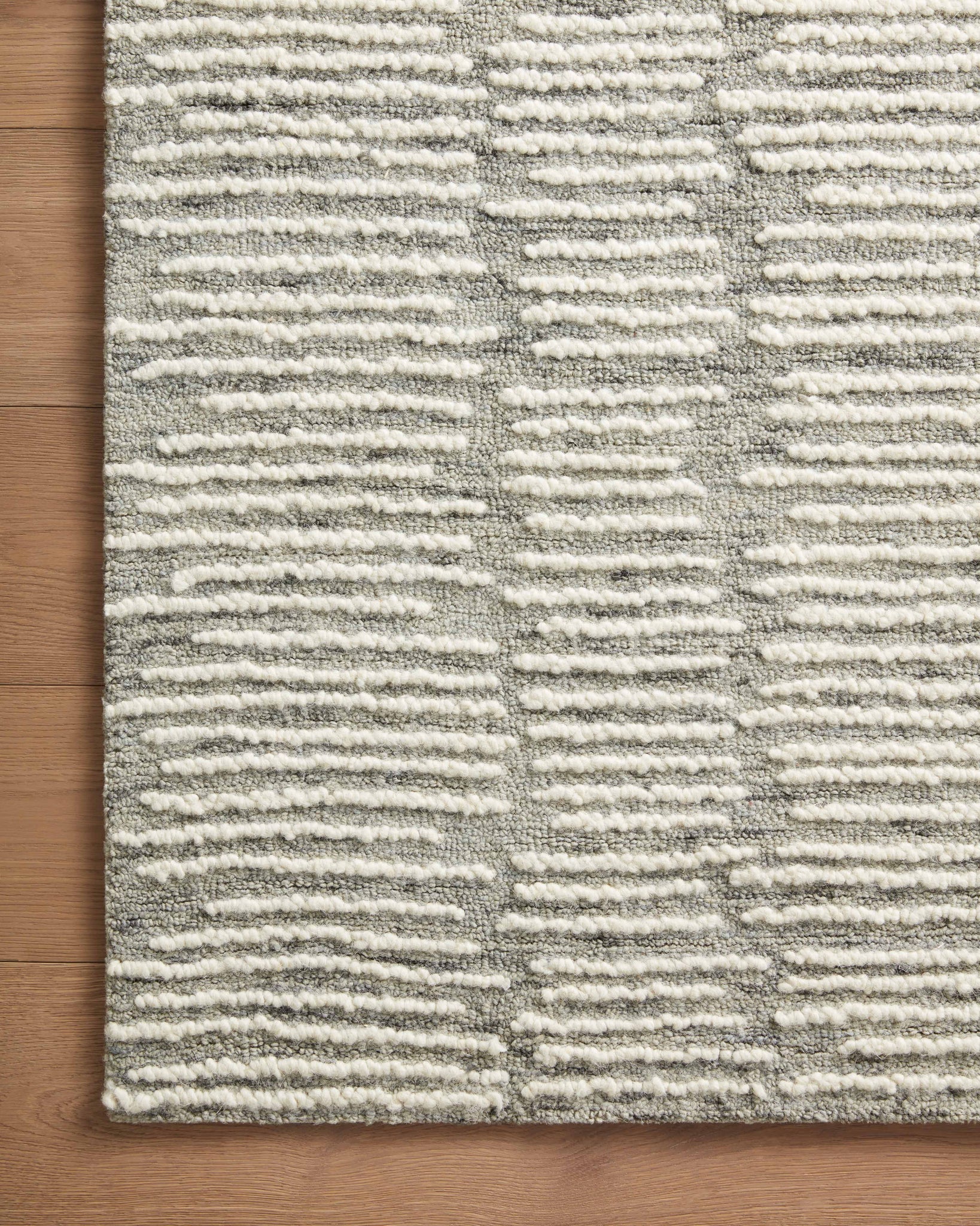 Side view of the Tallulah Stone / Ivory rug.