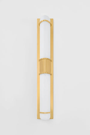 Tottenville Wall Sconce 4.25" x 27" in aged brass shown from the front to reveal the arm curve and shade silhouette.