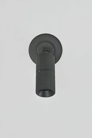 Close-up of the Truett Wall Sconce in dark bronze showing the arm curve and shade silhouette.