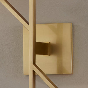 Close-up of the Tring Wall Sconce in aged brass showing the arm curve and shade silhouette.