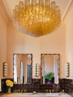 Emille Wall Sconce 6.75" x 18.25" styled in a curated living room for warm, layered light at Laurie Yapp Home.