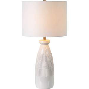 Nado Table Lamp illuminated, displaying a white shade and textured ceramic base