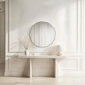 Knox mirror with a scalloped edge, reflecting light in a bright room with a white console table and decorative vase.