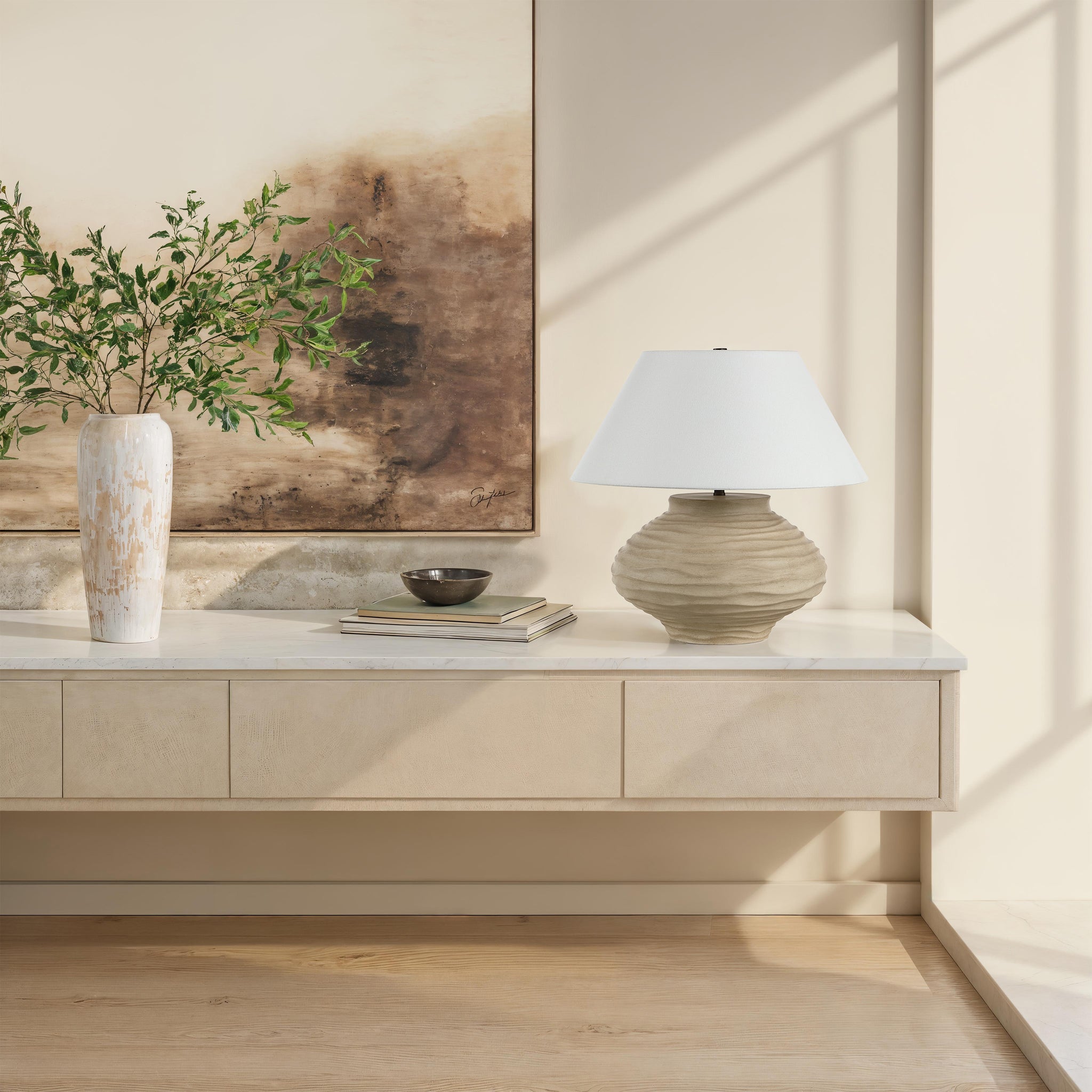 Ola table lamp by Renwil placed on a console table with decorative elements