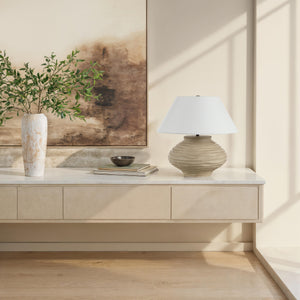 Ola table lamp by Renwil placed on a console table with decorative elements