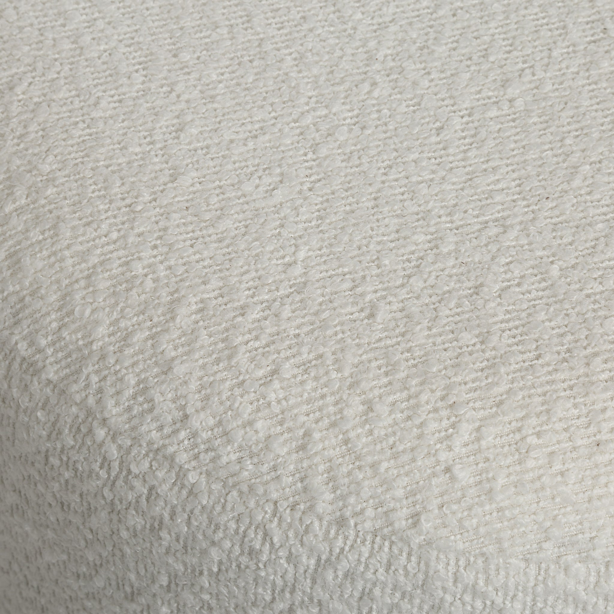 Chaves ottoman in textured white fabric, showcasing a soft, plush surface with a subtle pattern.