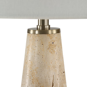 Close-up of Almeria table lamp base, featuring a textured beige stone and brushed metal accent.