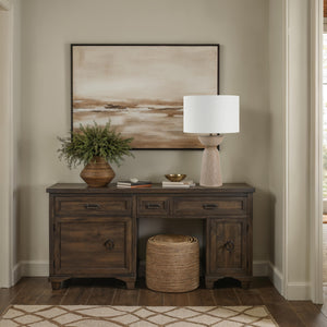 Alba Table Lamp on a dark wood console table, surrounded by decor and a large artwork.