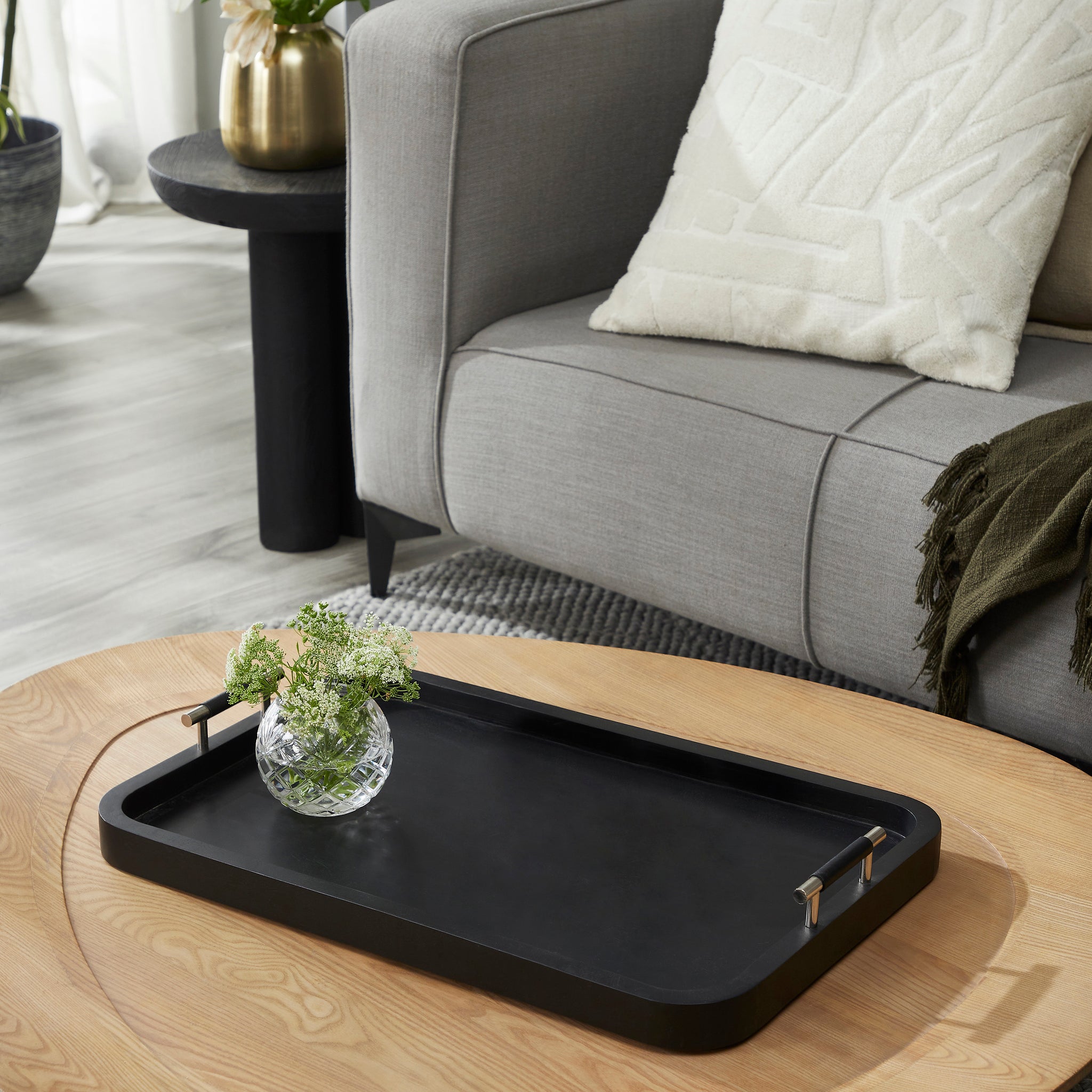 Hudson Tray by Renwil, black tray on wooden coffee table with flowers in a vase, styled living room.