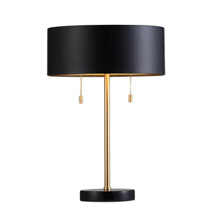 Gillian Table Lamp illuminated, showcasing a black shade and gold details.