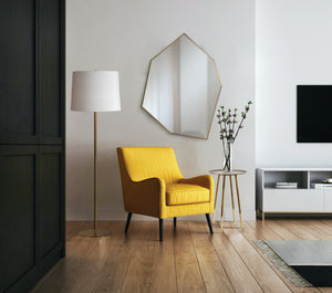 Radison Floor Lamp beside a yellow armchair in a modern living room setting.