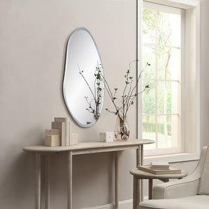 Anogia mirror by Renwil displayed in a room, mounted on wall above a console table with decor.