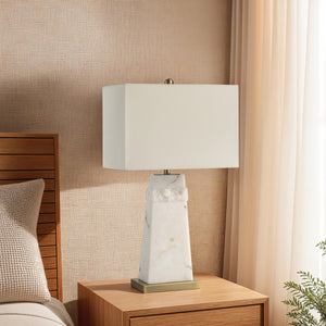 Nisrine Table Lamp on a nightstand, styled with a cozy bedroom background