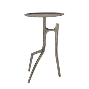Tosco table with a round metallic top and unique leg design in silver finish.