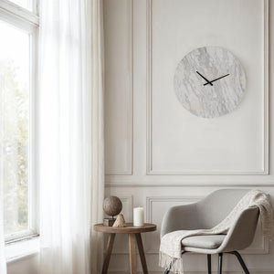 Dayton clock mounted on a wall in a bright room with a chair and decor