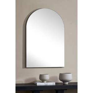 Faiza Wall Mirror displayed on a wall above a dark table with decorative vases.
