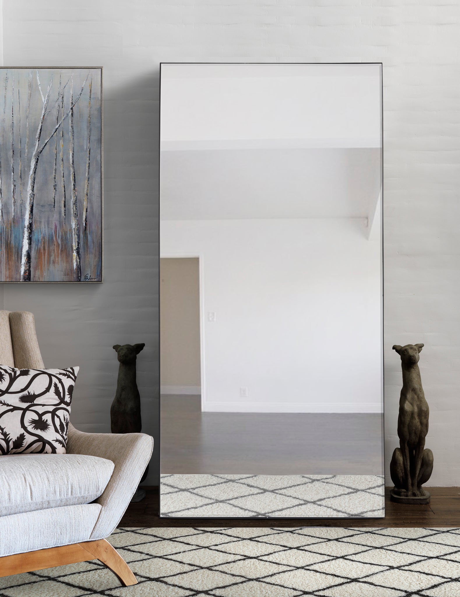 Trilo Full Length Mirror displayed in a modern living room with a cozy sofa and decorative art.
