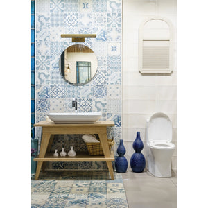 Swanson Wall Sconce displayed above a round mirror in a stylish bathroom setting