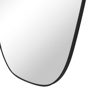 Close-up of Enina mirror by Renwil, highlighting the smooth reflective surface and rounded edges.