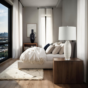Sereno Table Lamp on a bedside table in a modern bedroom with natural light.