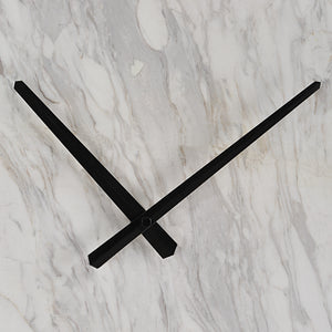 Detail view of black clock hands against a white marble background