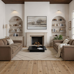 Pallini canvas art featuring a serene landscape with trees in soft neutral tones, framed and displayed above a fireplace.