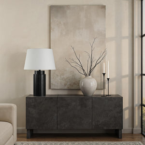 Stilus Table Lamp on a dark console table with decorative vase and branches