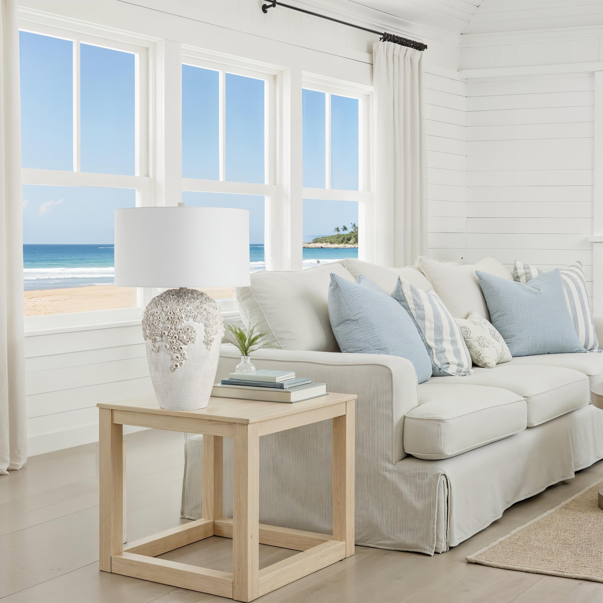 Wavy table lamp on a side table in a bright living room with beach view