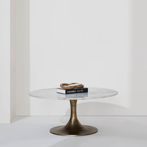 Lovisa Table styled with books and decorative rings on a white background.