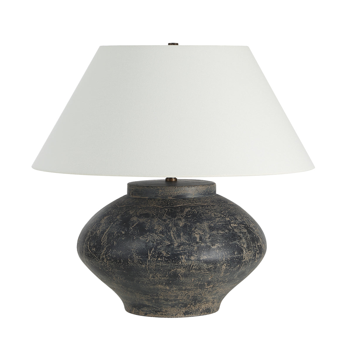 Patina table lamp with a round dark base and white fabric shade