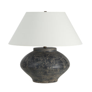 Patina table lamp with a round dark base and white fabric shade
