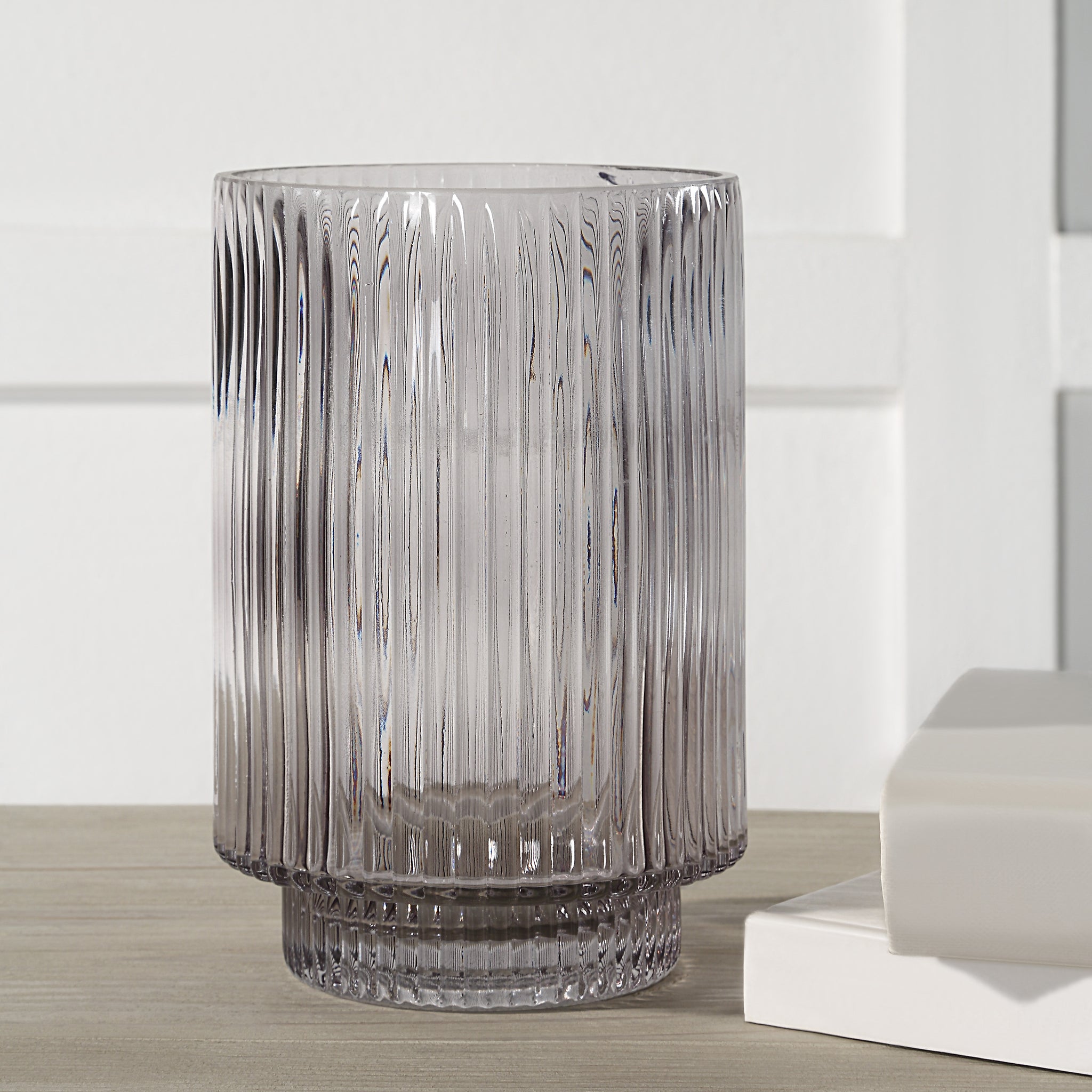 Amiens Indoor Mouth Blown Glass Vase in grey, fluted design displayed on a wooden surface.