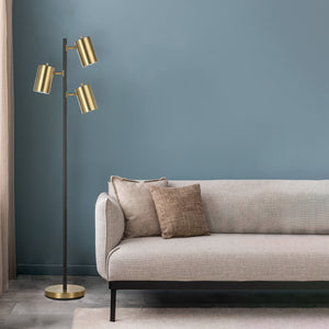 Mosaic floor lamp beside a light gray sofa with decorative pillows against a blue wall.