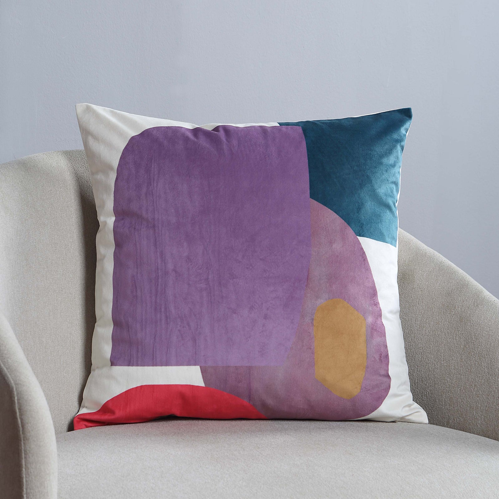 Layla Indoor Pillow featuring abstract shapes in purple, teal, red, and beige on a white background.