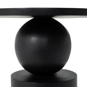 Close-up view of Paola side table's spherical base and round top in black.