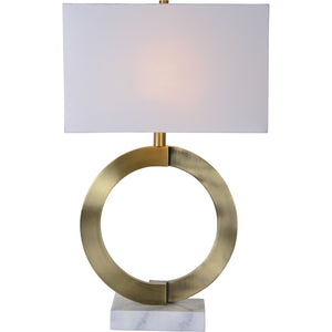 Skylar Table Lamp illuminated with a soft glow, featuring a brass base and white shade.