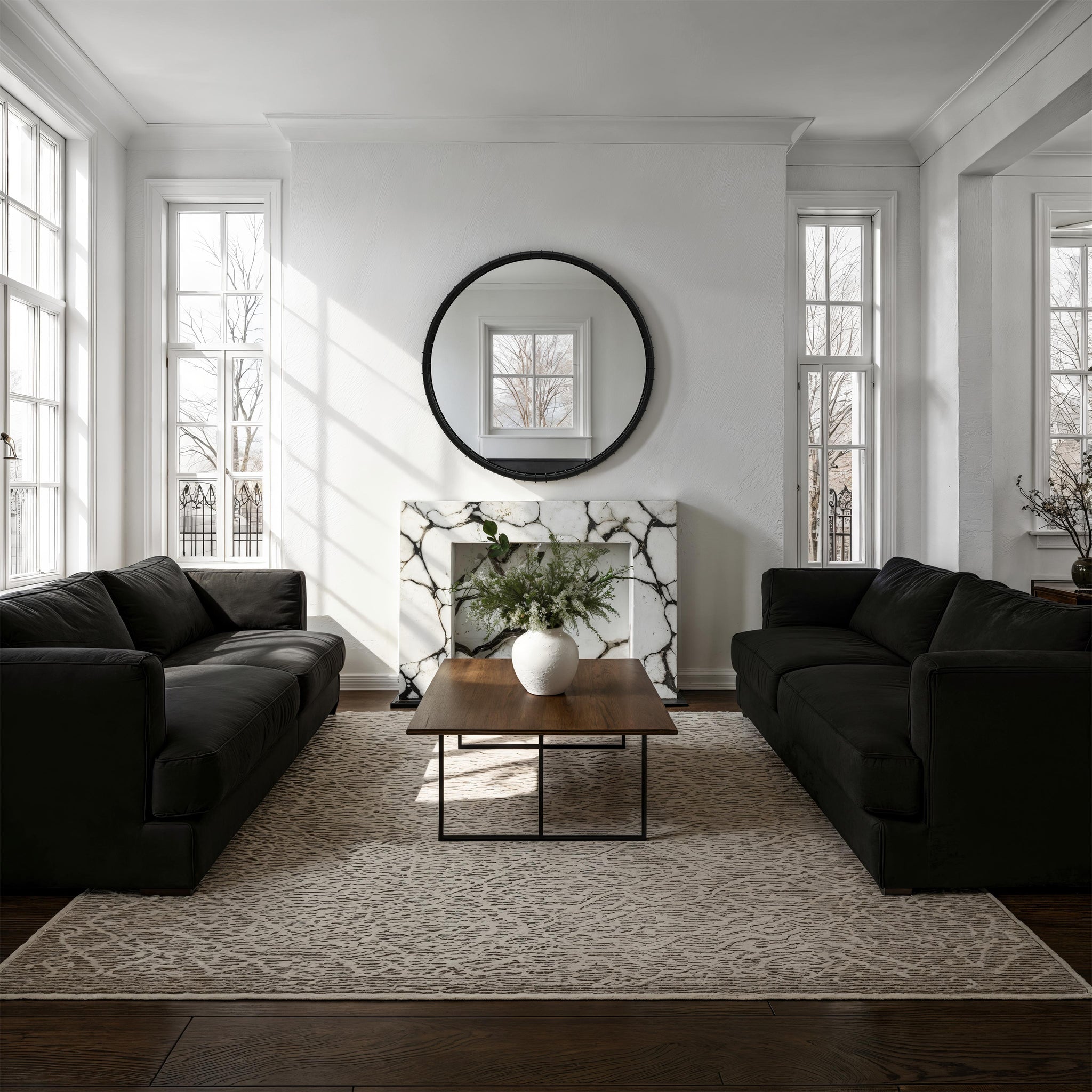 Timo mirror displayed in a modern living room, above a marble fireplace with natural light.