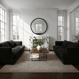 Timo mirror displayed in a modern living room, above a marble fireplace with natural light.