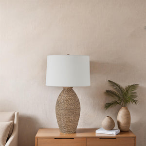 Santal Table Lamp on a wooden table with decorative items and a textured wall