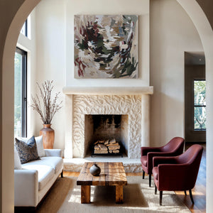 Ardesia canvas art featuring abstract brush strokes in earthy tones above a stone fireplace