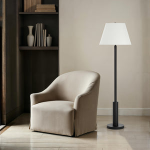 Pantera Floor Lamp by Renwil next to a beige armchair in a modern setting.