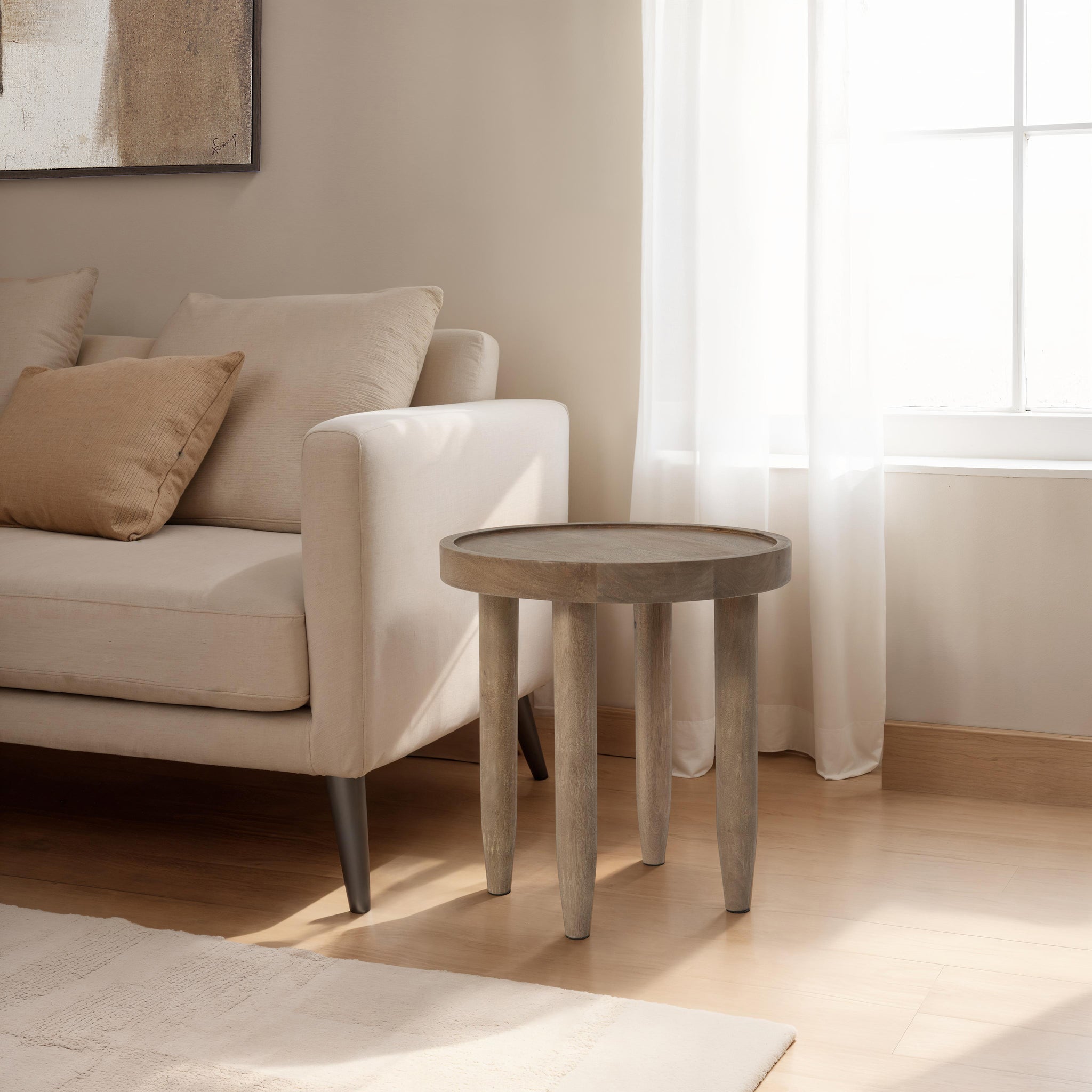Cicoria side table placed beside a light-colored sofa in a bright living room