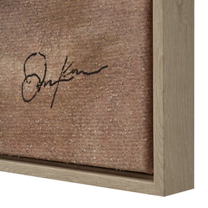 Close-up of Onda canvas art signature on textured surface, showcasing subtle hues and a wooden frame.