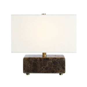 Cabo table lamp illuminated, featuring a white shade and dark marble base.